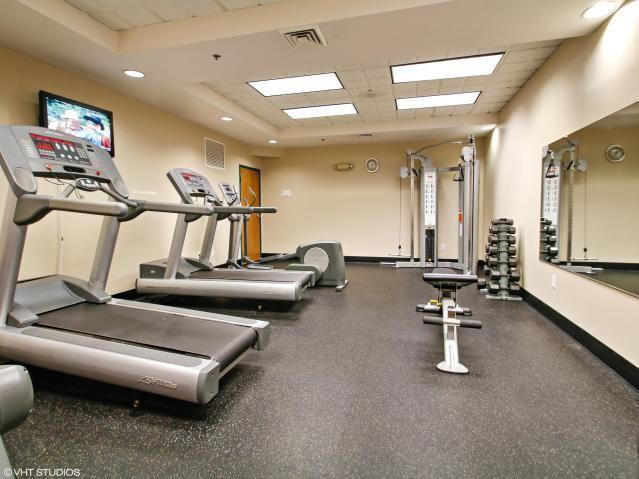 exercise room featuring a tray ceiling