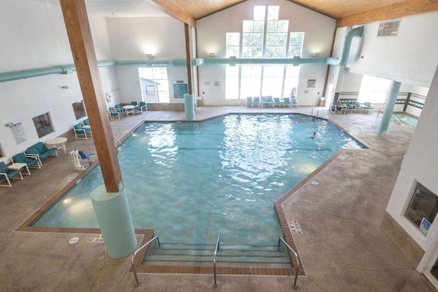 view of swimming pool featuring a hot tub