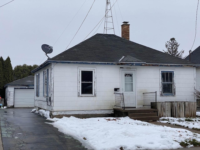 view of front of home featuring a garage and an outdoor structure