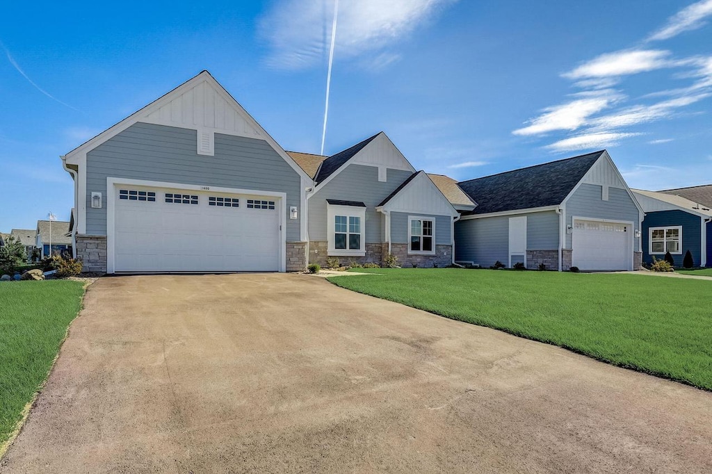view of front of house with a front yard and a garage