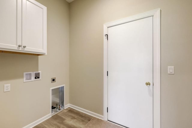 washroom with light hardwood / wood-style floors, hookup for a washing machine, cabinets, and hookup for an electric dryer