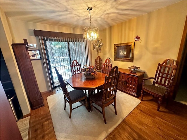 dining area with a chandelier and hardwood / wood-style floors