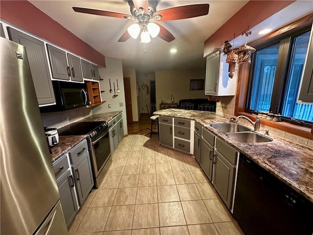 kitchen featuring gray cabinetry, ceiling fan, sink, stainless steel appliances, and light tile patterned flooring