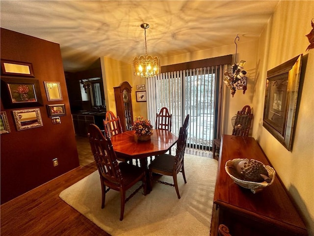 dining space featuring hardwood / wood-style flooring, a notable chandelier, and sink