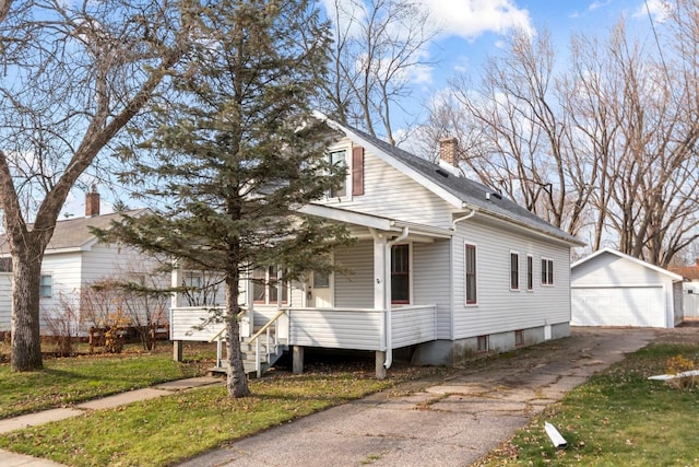 view of property exterior featuring a porch, an outdoor structure, and a garage