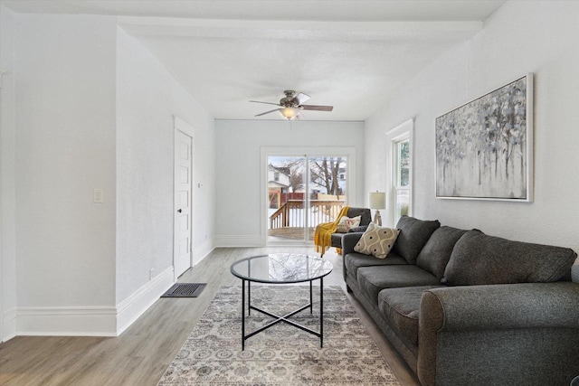 living room featuring hardwood / wood-style flooring and ceiling fan