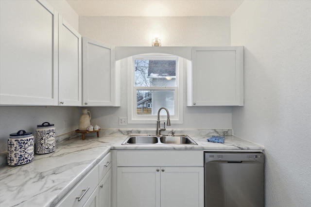 kitchen with white cabinets, dishwasher, light stone countertops, and sink