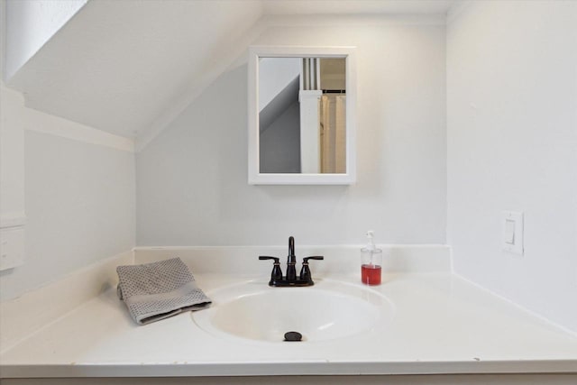 bathroom with vanity and vaulted ceiling