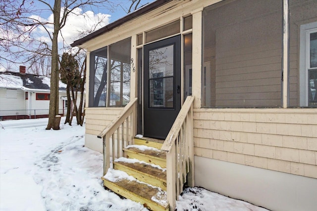 view of snow covered property entrance