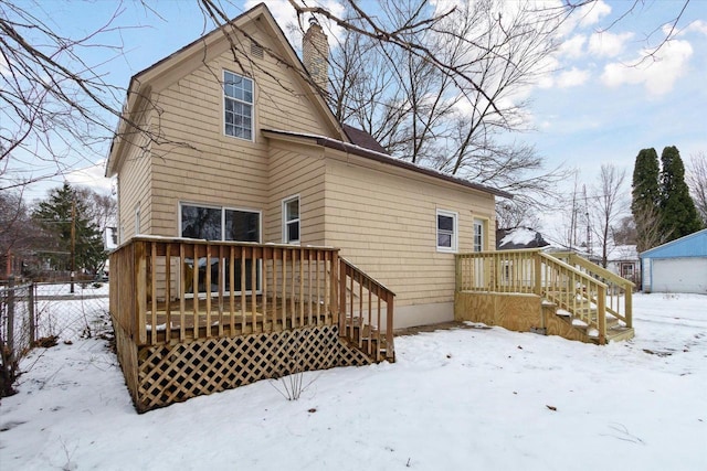 view of snow covered rear of property