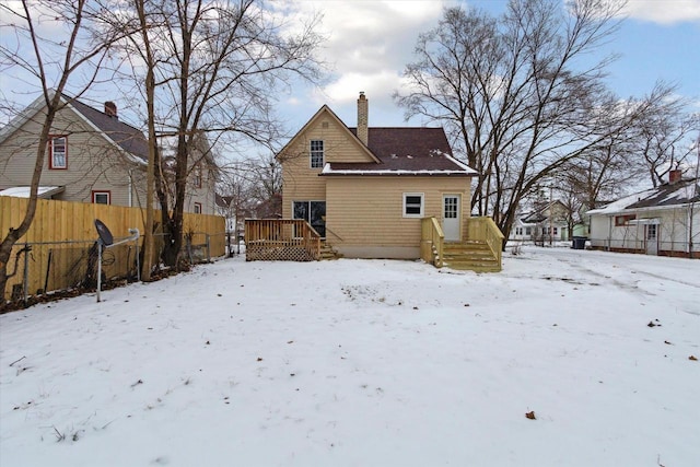 view of snow covered back of property