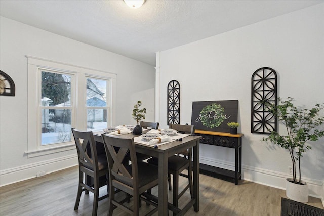 dining area featuring a textured ceiling and dark wood-type flooring