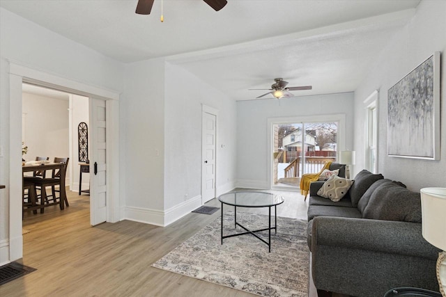 living room with hardwood / wood-style flooring and ceiling fan