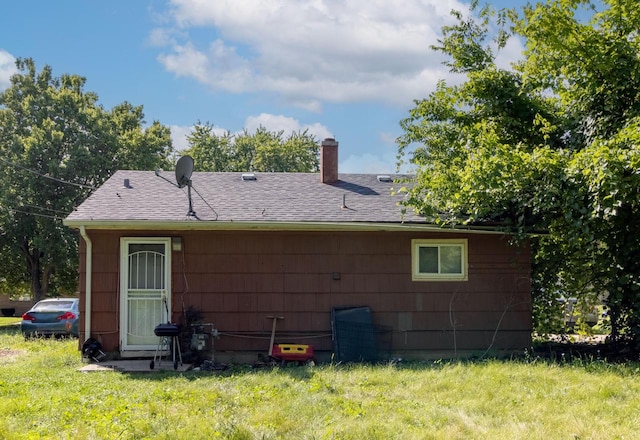 rear view of house featuring a lawn