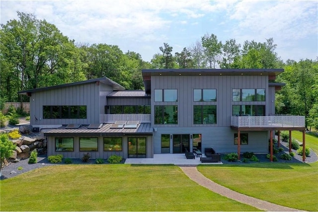 rear view of property with a patio area and a lawn