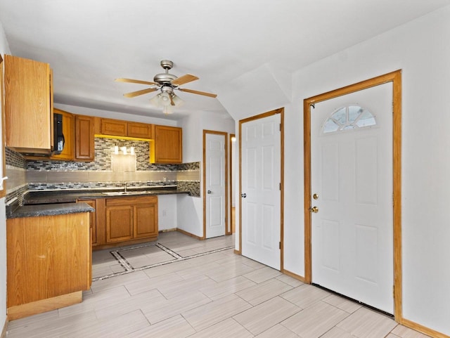 kitchen with ceiling fan, sink, and tasteful backsplash