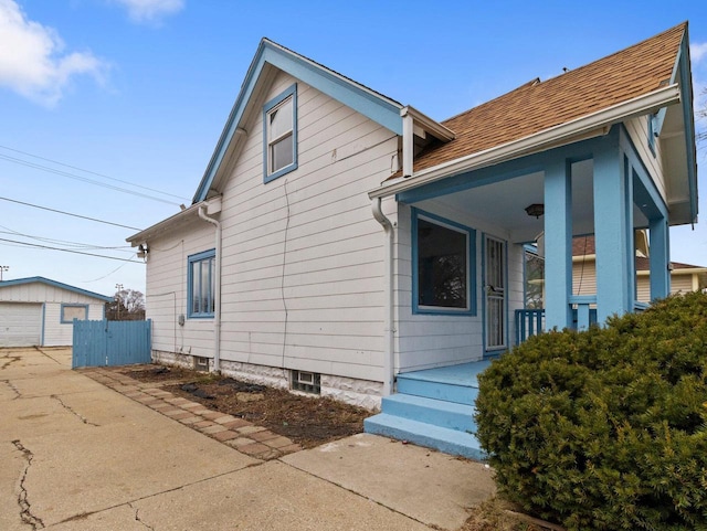 view of front of house featuring covered porch, an outbuilding, and a garage