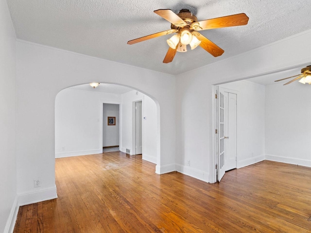 unfurnished room featuring wood-type flooring, a textured ceiling, and ceiling fan