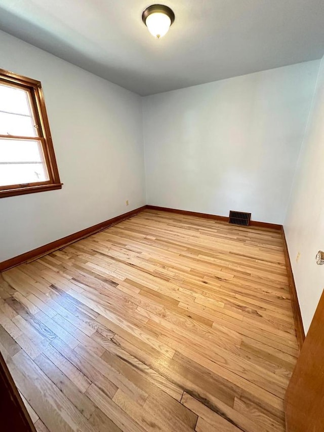 spare room featuring light hardwood / wood-style flooring