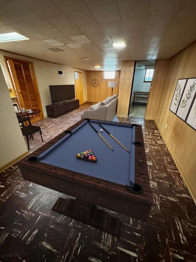 recreation room with wooden walls and billiards