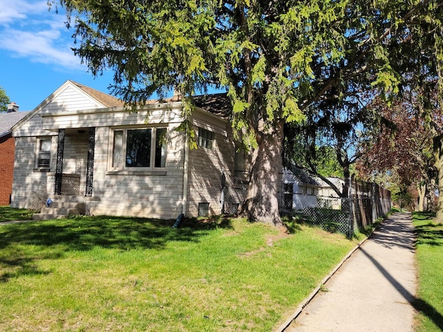 view of side of property with a lawn