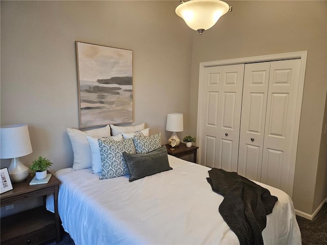 bedroom with dark carpet and a closet