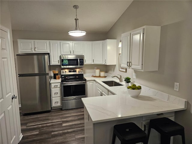 kitchen featuring white cabinetry, kitchen peninsula, sink, and appliances with stainless steel finishes