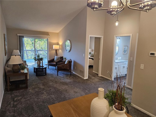 carpeted living room featuring high vaulted ceiling and an inviting chandelier