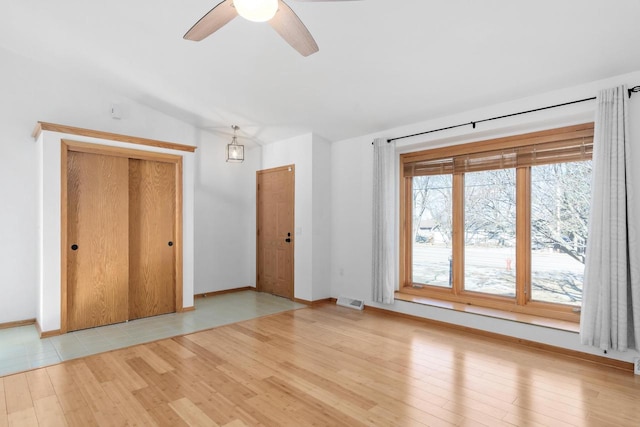 interior space featuring ceiling fan, light hardwood / wood-style flooring, and lofted ceiling