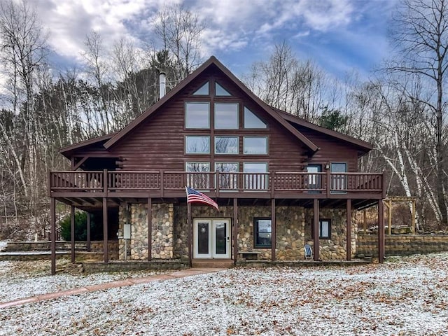 snow covered property with a deck