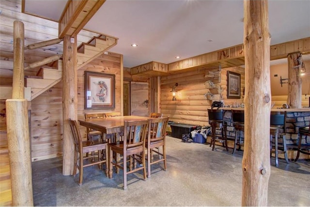 dining space with rustic walls