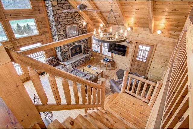 stairway featuring beam ceiling, hardwood / wood-style floors, and wooden ceiling