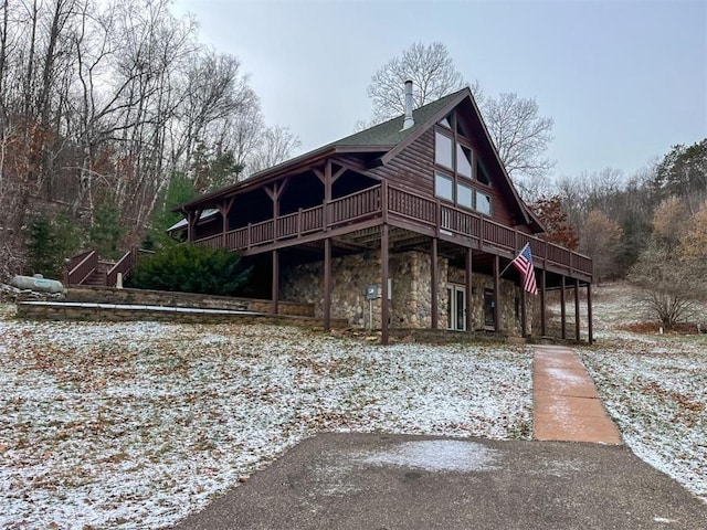 rear view of house featuring a deck