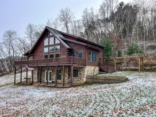 snow covered property featuring a deck