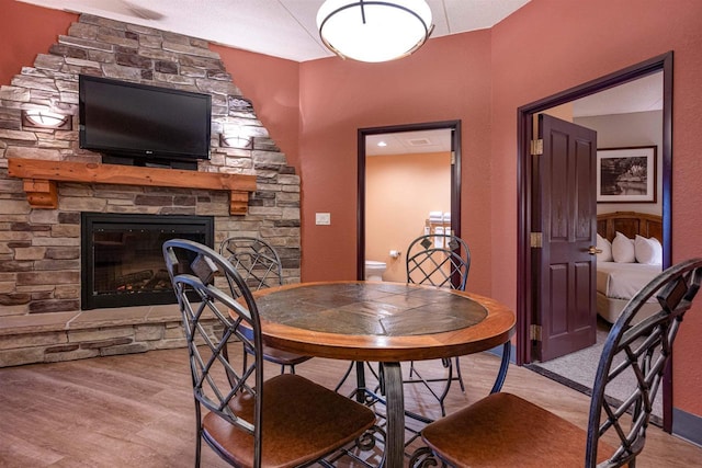 dining area with a fireplace and light hardwood / wood-style flooring