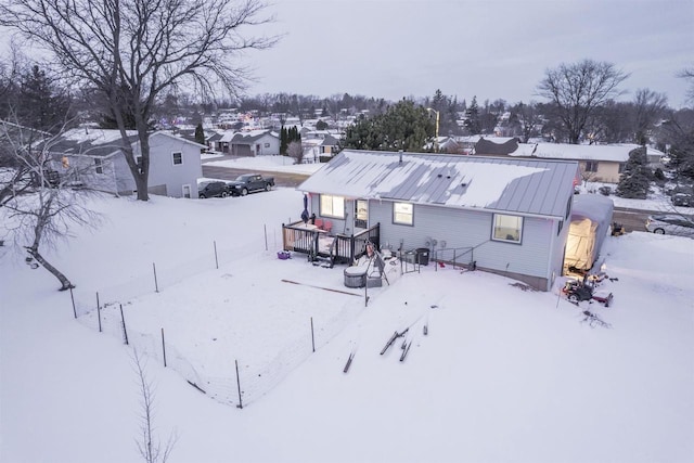 snow covered property featuring a wooden deck