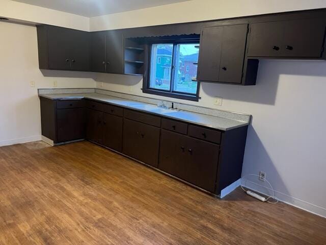 kitchen featuring dark brown cabinetry and light hardwood / wood-style flooring