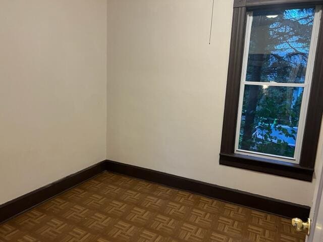 unfurnished room with parquet flooring