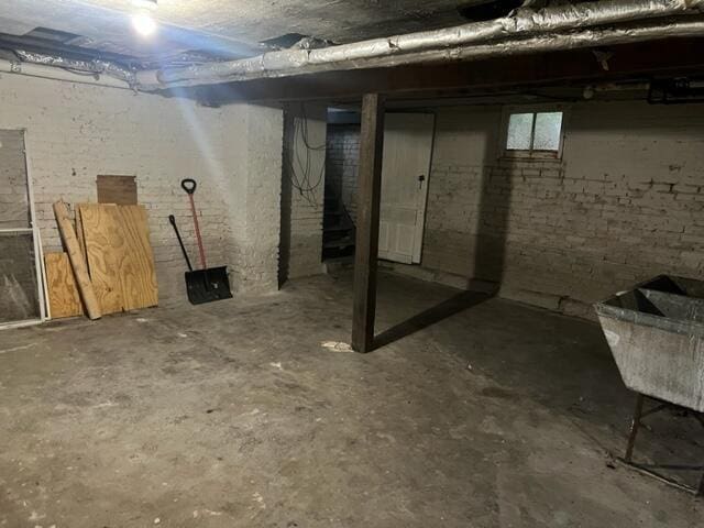 basement with brick wall