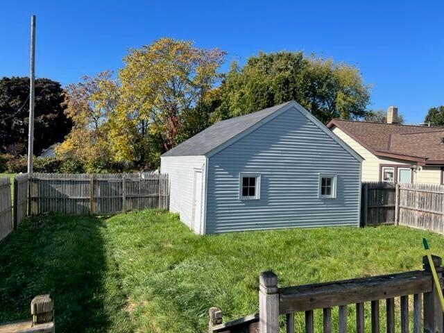 view of home's exterior featuring an outbuilding and a yard