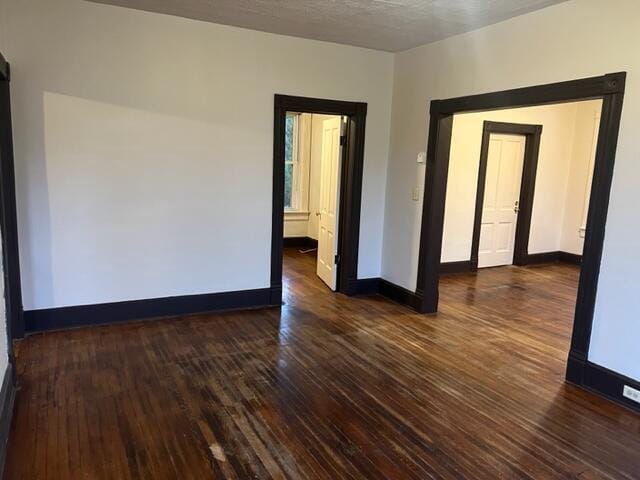 empty room with dark hardwood / wood-style floors