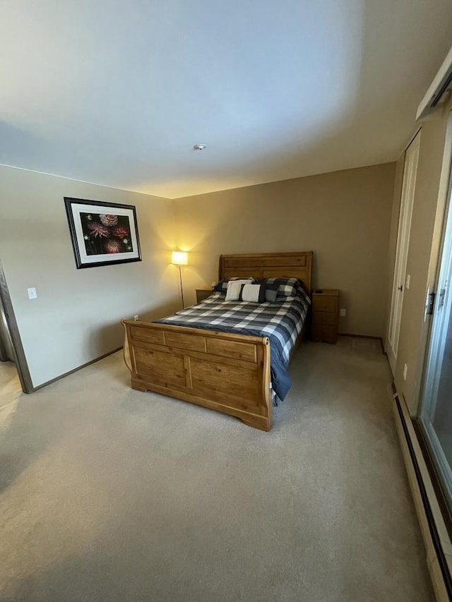 bedroom featuring light colored carpet and baseboard heating