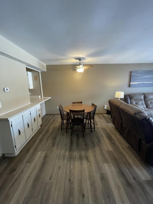 dining space featuring dark hardwood / wood-style floors and ceiling fan