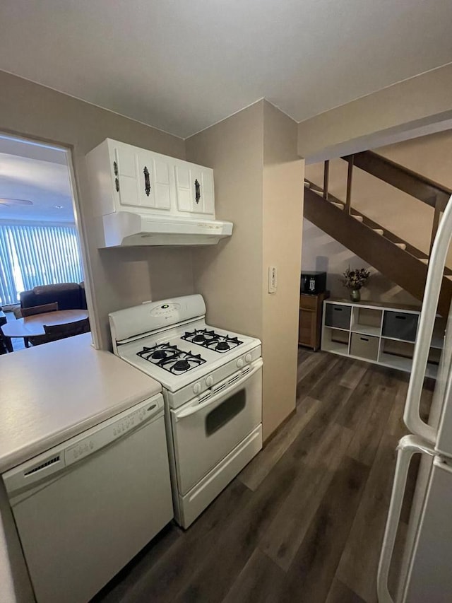 kitchen with white cabinets, white appliances, and dark hardwood / wood-style floors