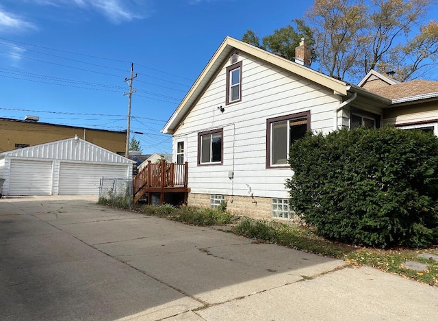 view of side of property featuring an outdoor structure and a garage