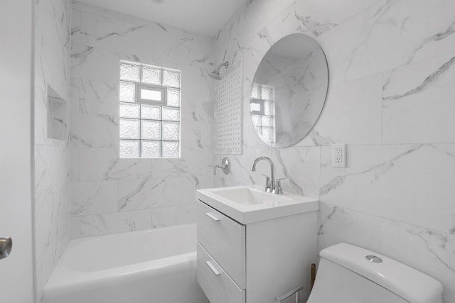 full bathroom featuring tile walls, vanity,  shower combination, and toilet