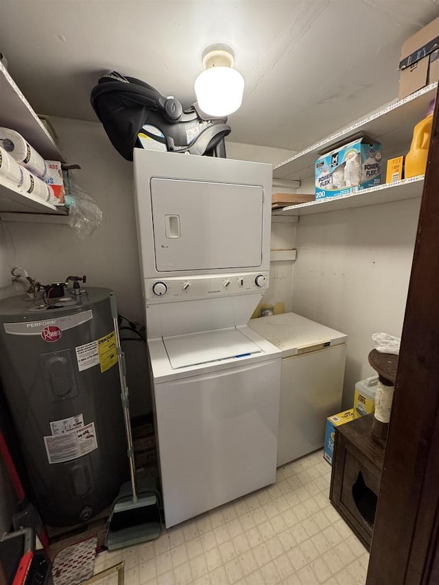 laundry room featuring electric water heater and stacked washer and dryer