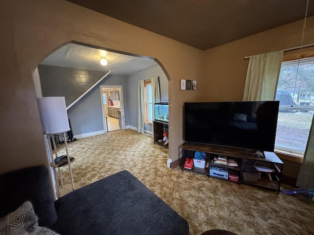 carpeted living room with a healthy amount of sunlight