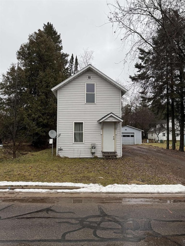 view of front facade with a garage and an outdoor structure