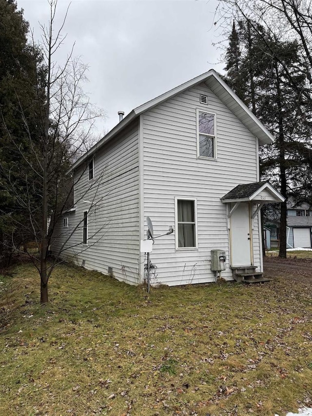 rear view of house with a lawn